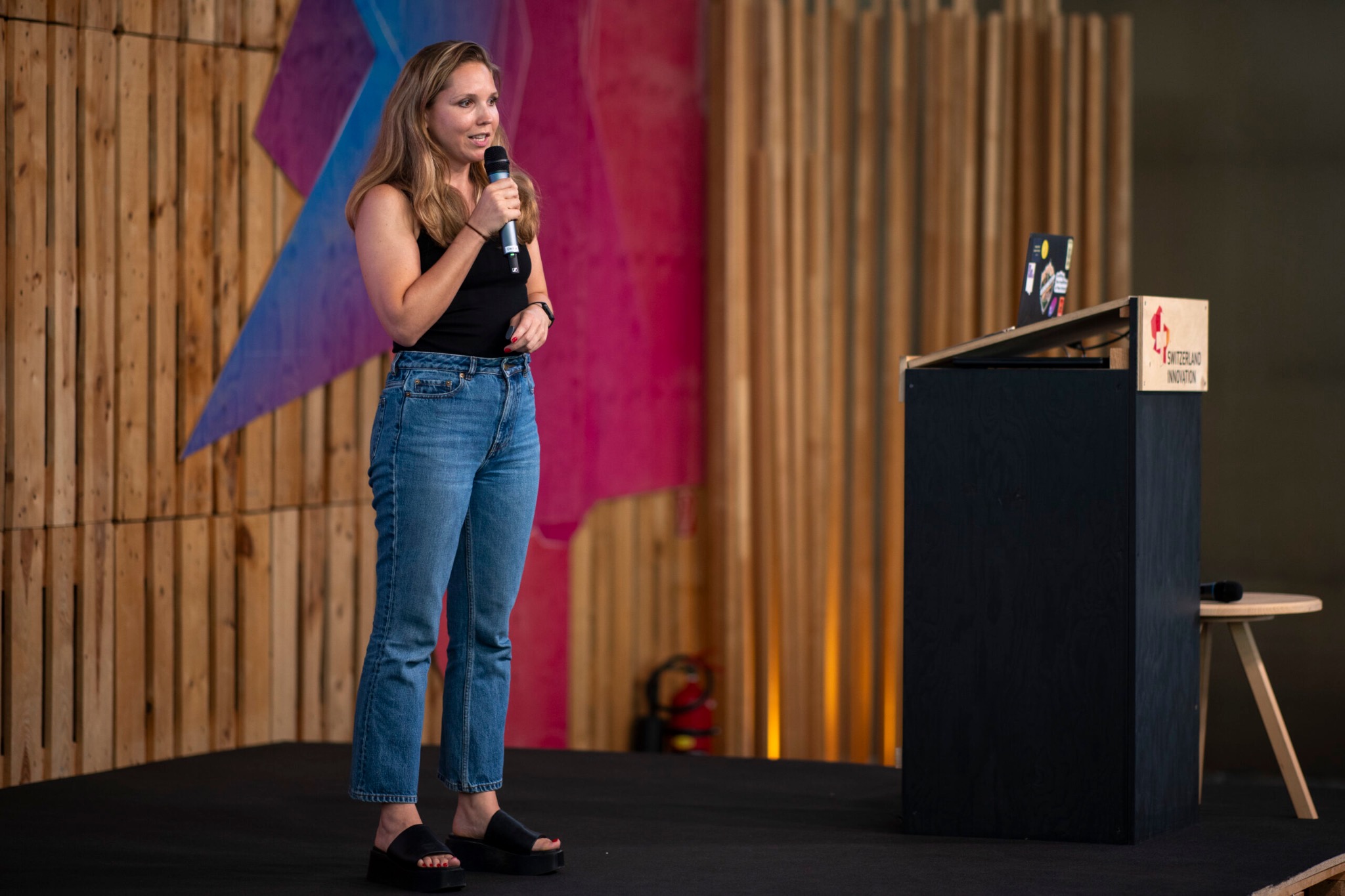Female founder presenting on stage